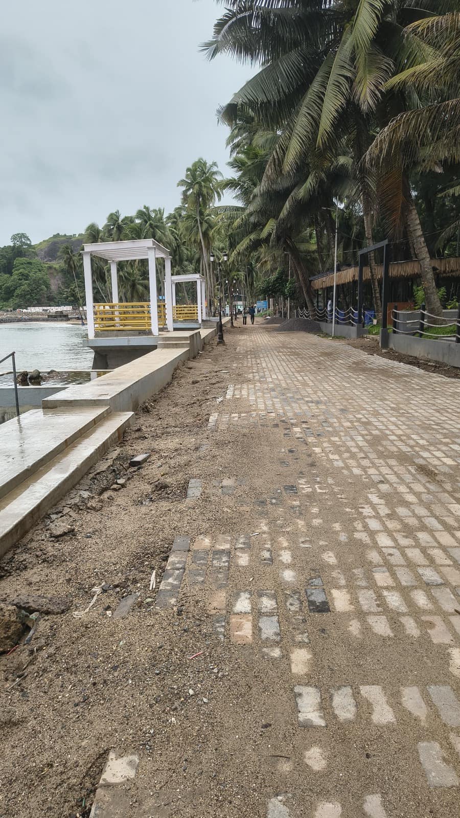 Palm-shaded seafront promenade with pergolas at Corbyn's Cove, Port Blair