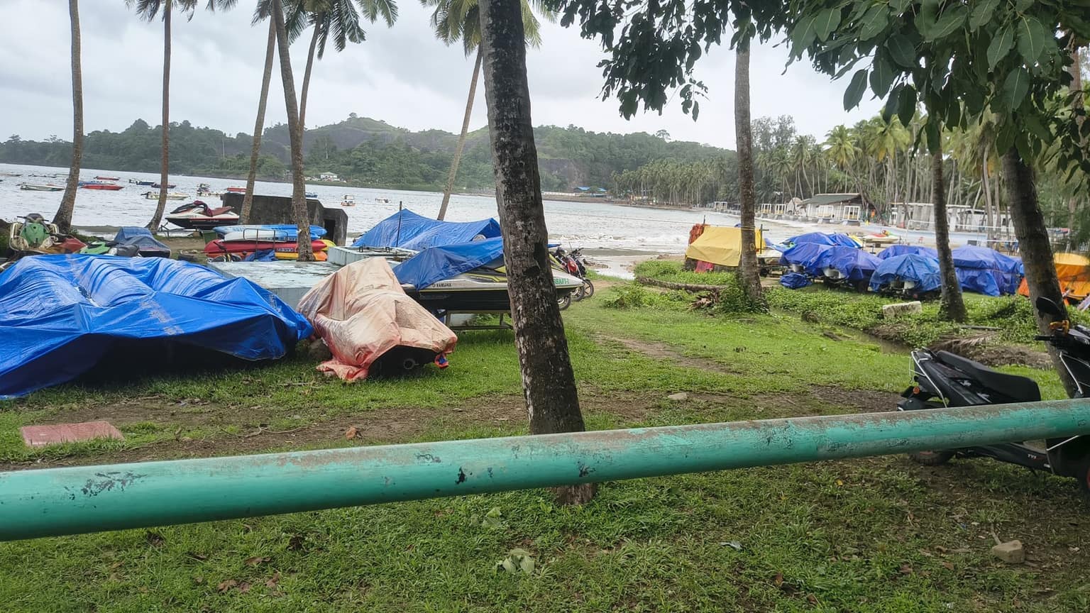 The cove at Corbyn's Cove in the monsoon, water-sports fleet stored under tarpaulins