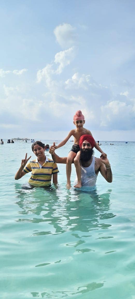 Family in the shallows at Elephant Beach, Havelock