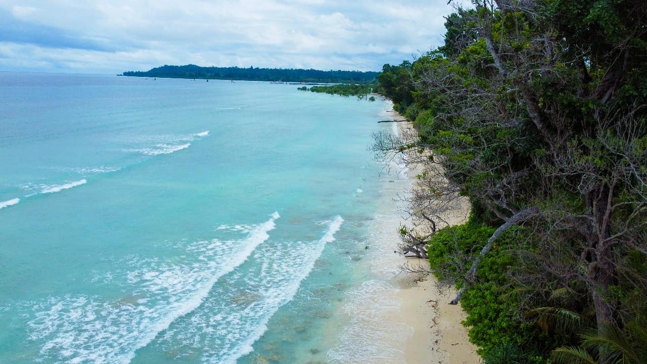 Kalapathar coastline from above in December with lines of white surf against turquoise water