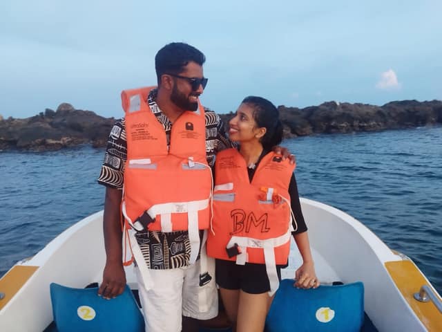 Boat passing rock formations in open Andaman water