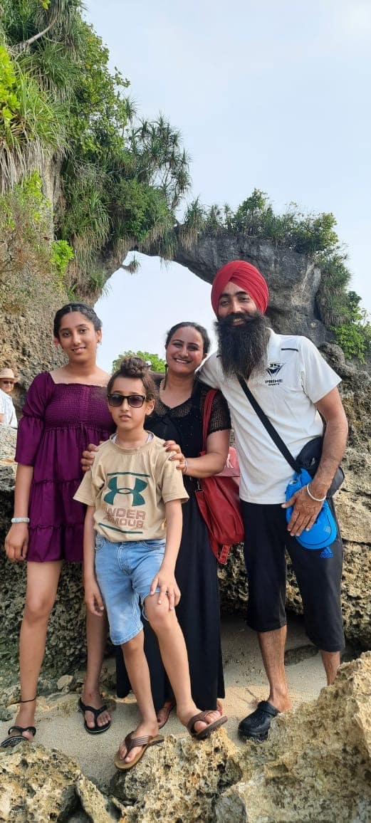 A family on the walk out to the Natural Bridge rock formation on Neil Island