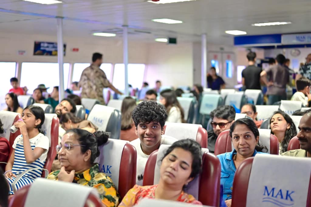 Passengers seated inside the air-conditioned cabin of an inter-island ferry