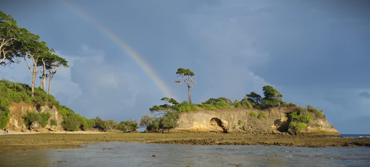 A rainbow over the Natural Bridge coastline on Neil Island after a passing storm