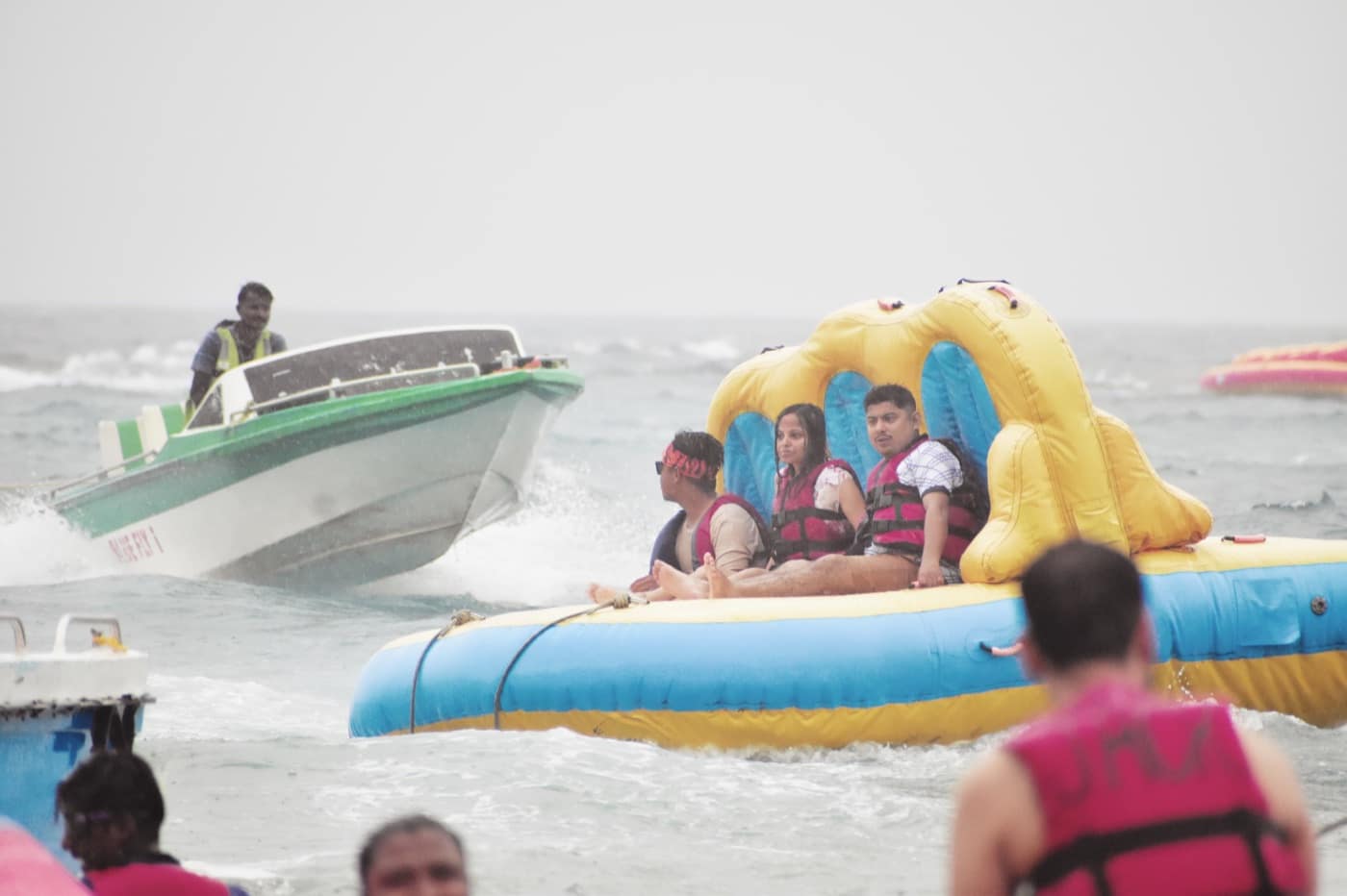 Travellers on a banana-boat ride in calm water at North Bay Island, photographed in October